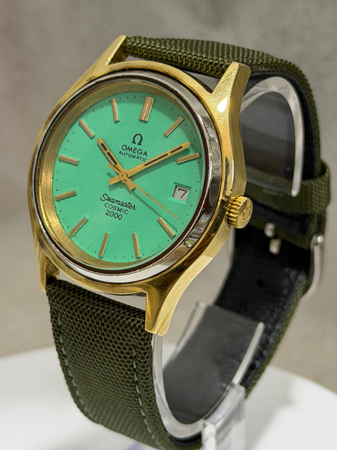 W017 Omega Seamaster Cosmic 2000 Automatic, turquoise-green dial, 38 mm — crown-side view