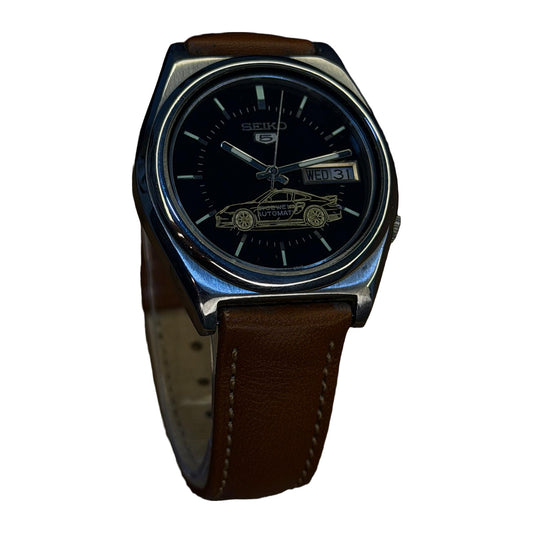 Seiko 5 Automatic Day-Date Black Dial w/ Car Motif on a white background