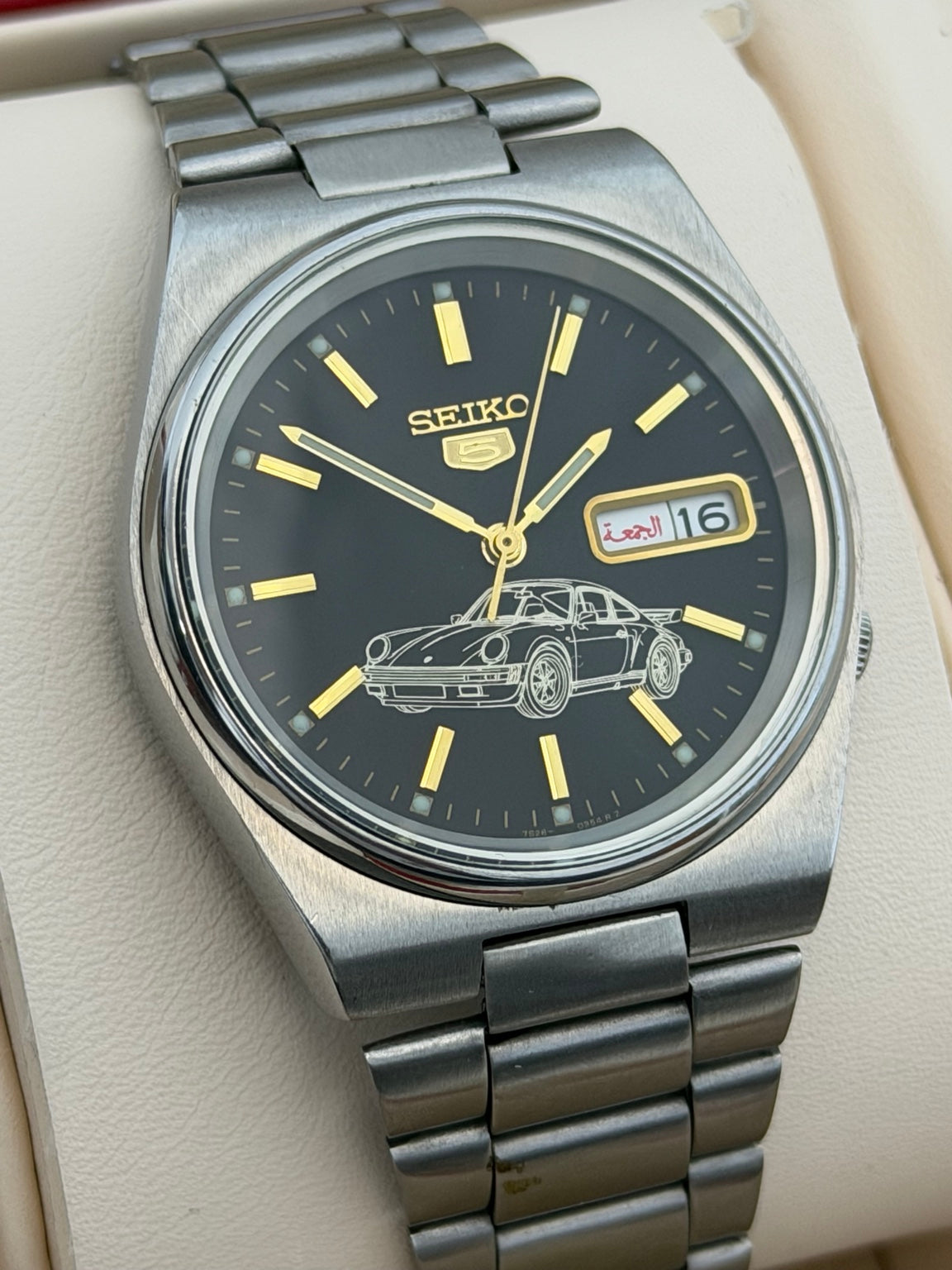Vintage Seiko 5 automatic watch black dial with sports car motif front view